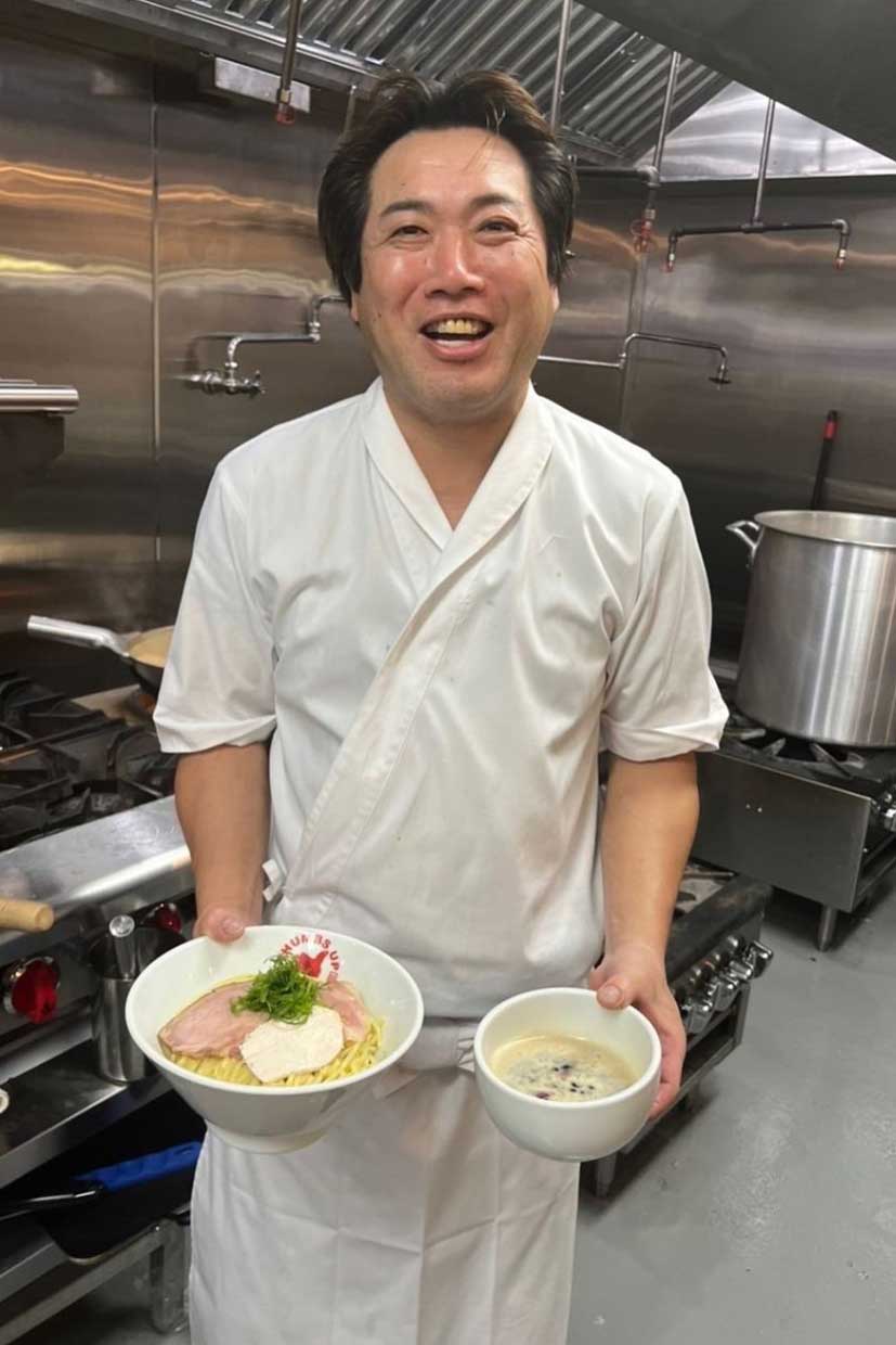 Chef Naotaka Miyazawa holding tori paitan tsukemen (dipping noodles)